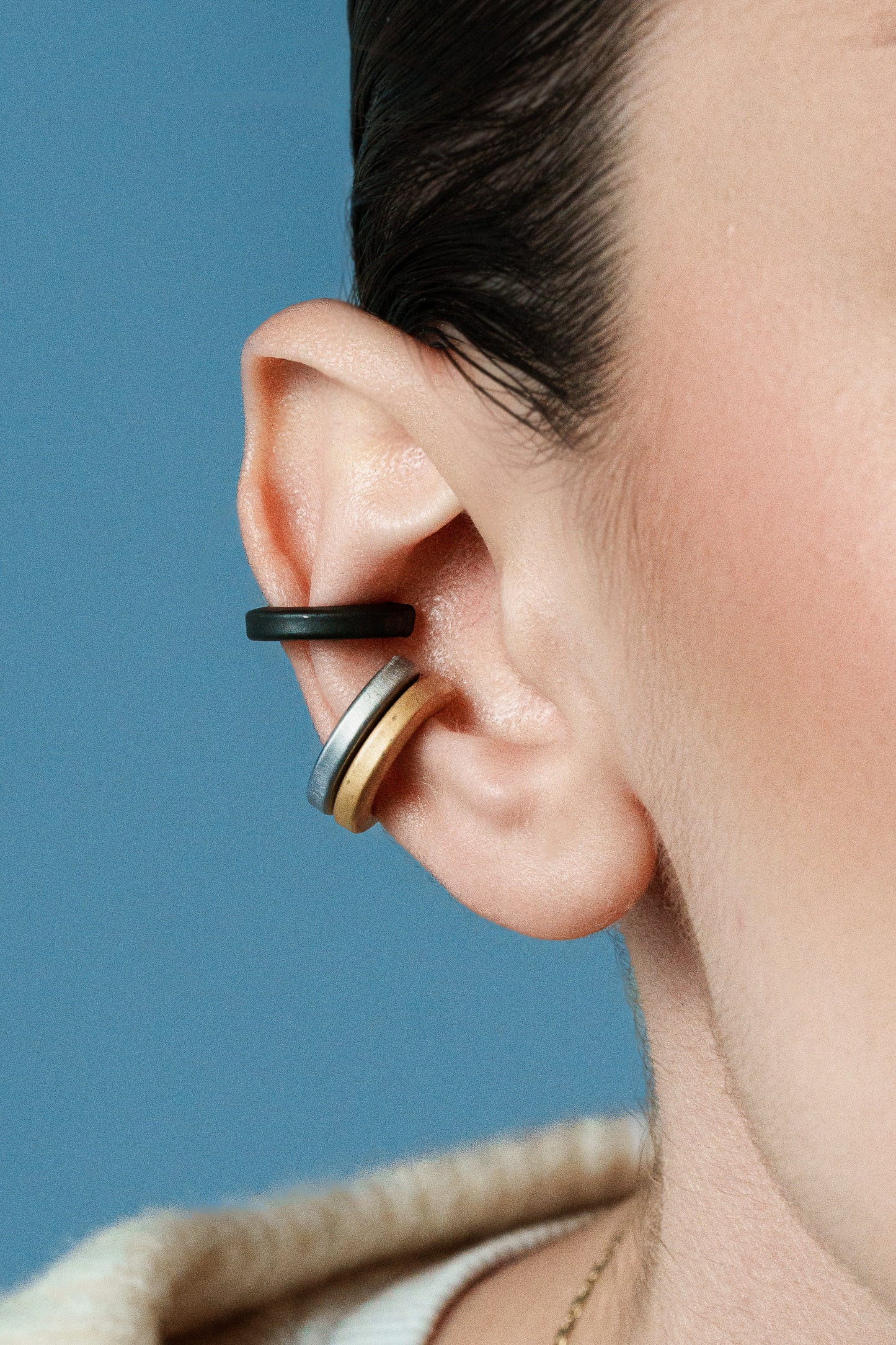 Chic Circulars, Polished bronze earcuffs that offer a sleek, sophisticated look, perfect for elevating any outfit.
Available in black, gold and silver tones.