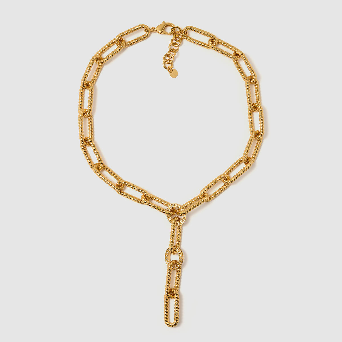 Tidal Chains, A modern Y-chain necklace crafted from brass, featuring bold geometric links accented with sparkling zircon stones.