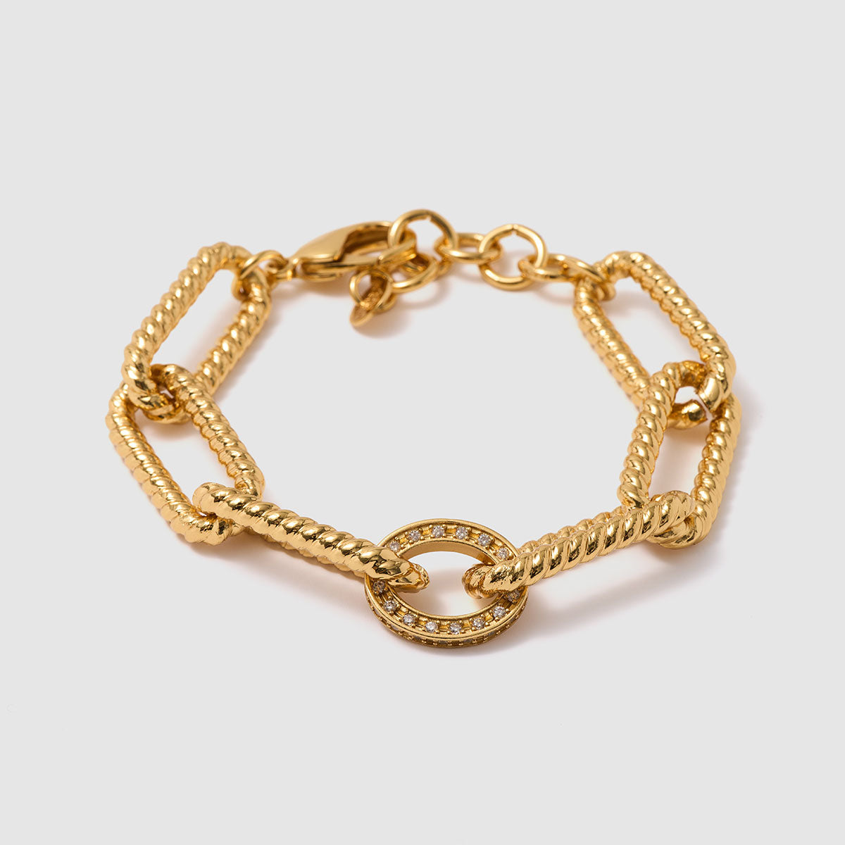 Tidal Chains, Distinctive chain bracelet crafted from brass, featuring striking geometric links and a central circle accent adorned with shimmering zircon stones.