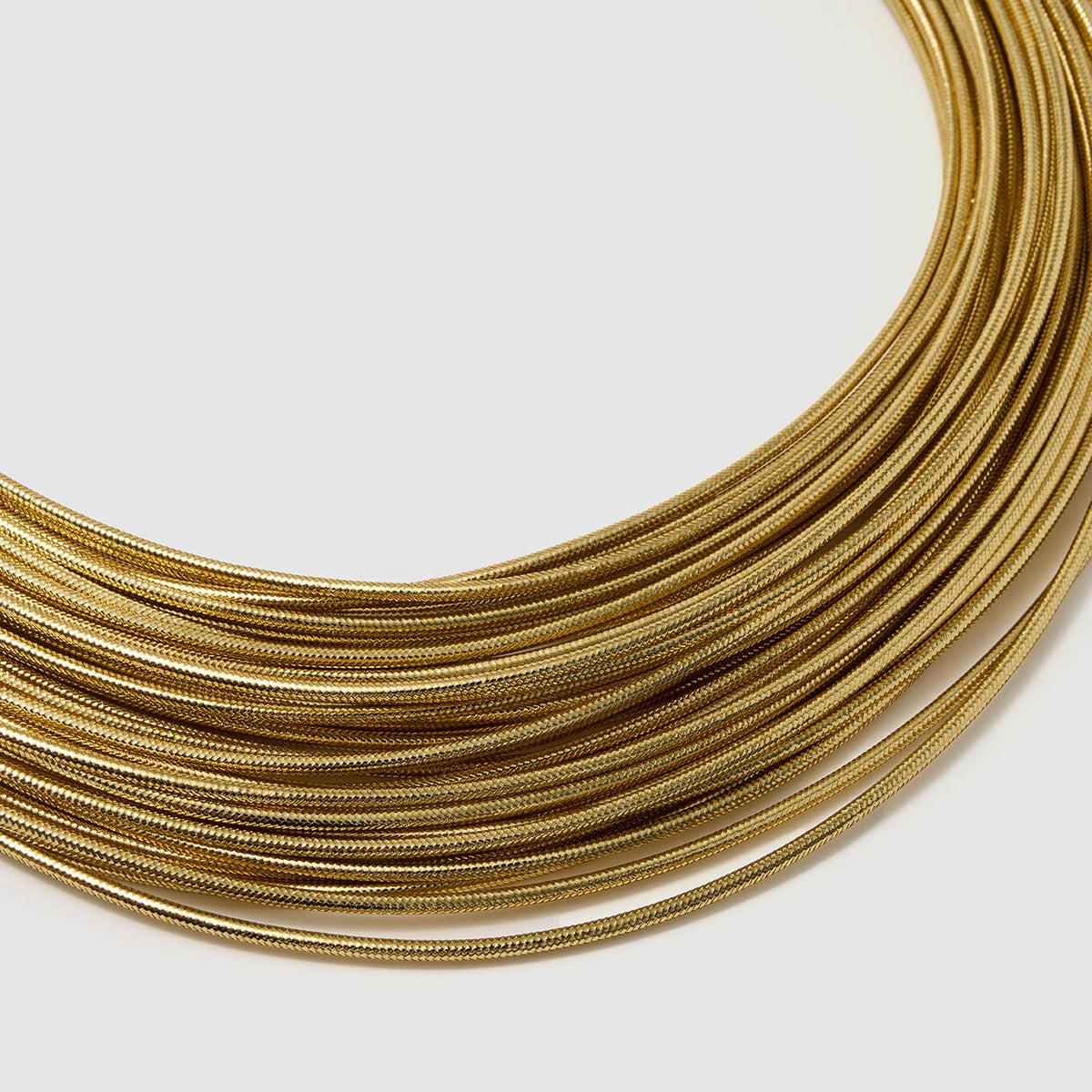 Imperial Strands, A striking silver multi-layered necklace crafted from a blend of bronze, lurex, metal and thermoplastic, offering a modern twist on classic elegance.
Available in gold and silver finishes.