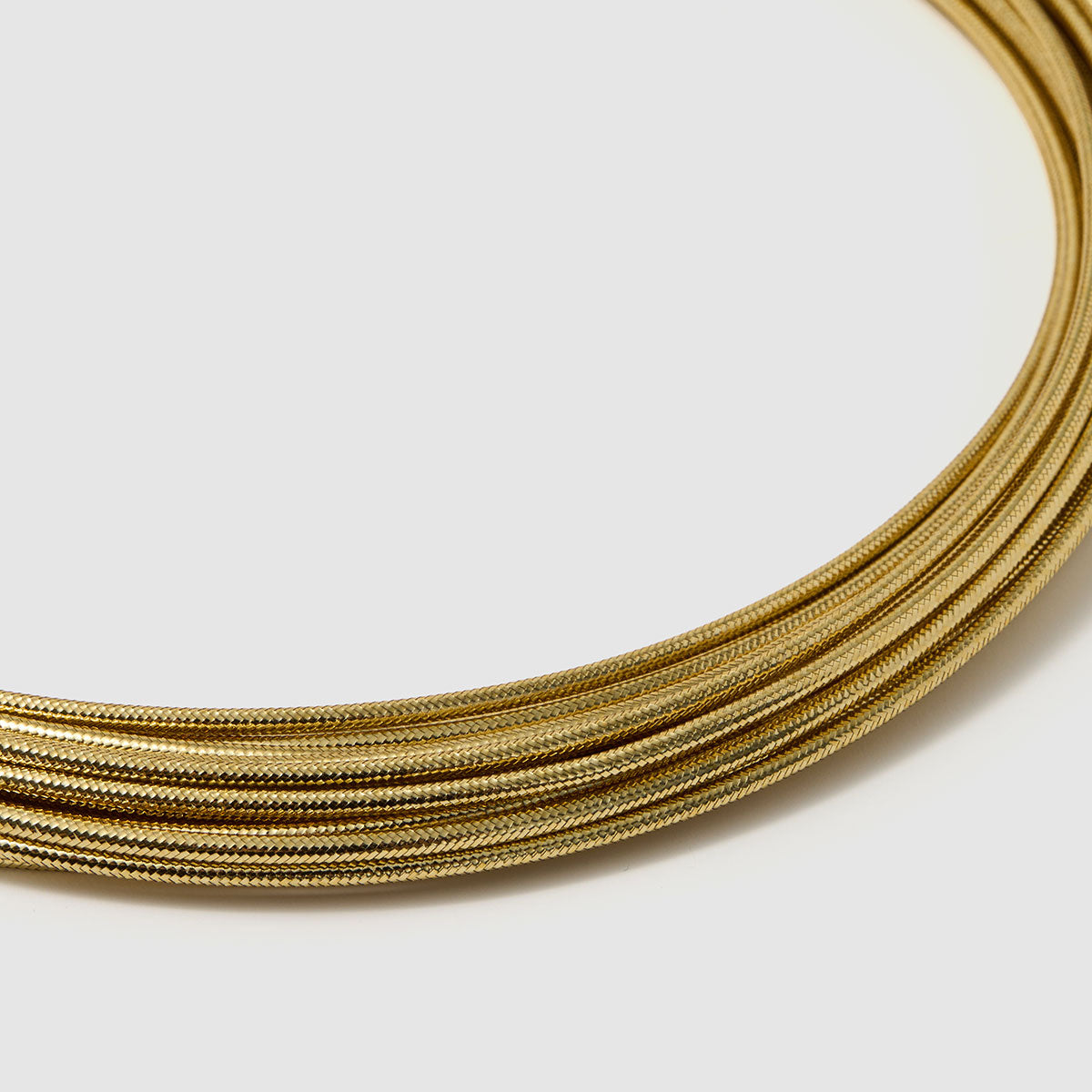 Imperial Strands, A striking silver multi-layered necklace crafted from a blend of bronze, lurex, metal and thermoplastic, offering a modern twist on classic elegance.
Available in gold and silver finishes.