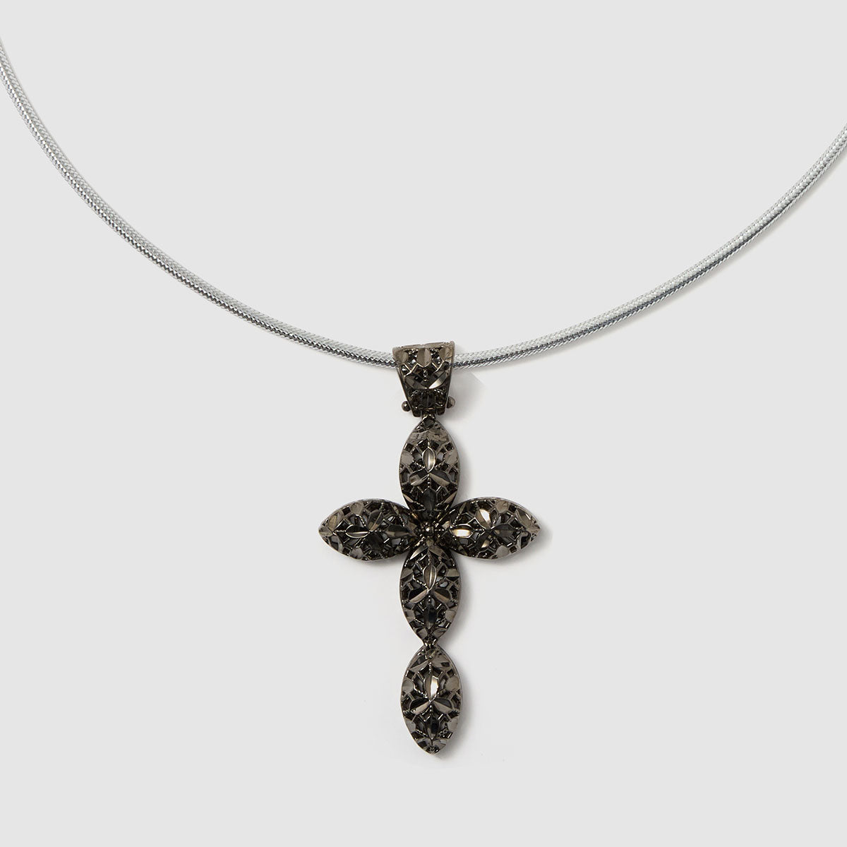 Crossroads of Time, A decorative cross pendant in black-tone bronze, featuring detailed artistry that merges modern style with spiritual significance.
Available in gold and black tones.