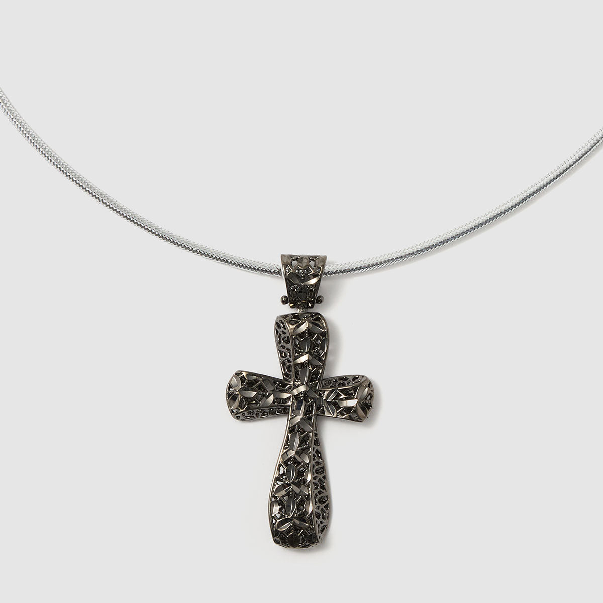 Crossroads of Time, A striking bronze cross pendant with a unique textured finish, merging tradition with a modern edge for a bold statement.
Available in gold and black tones.