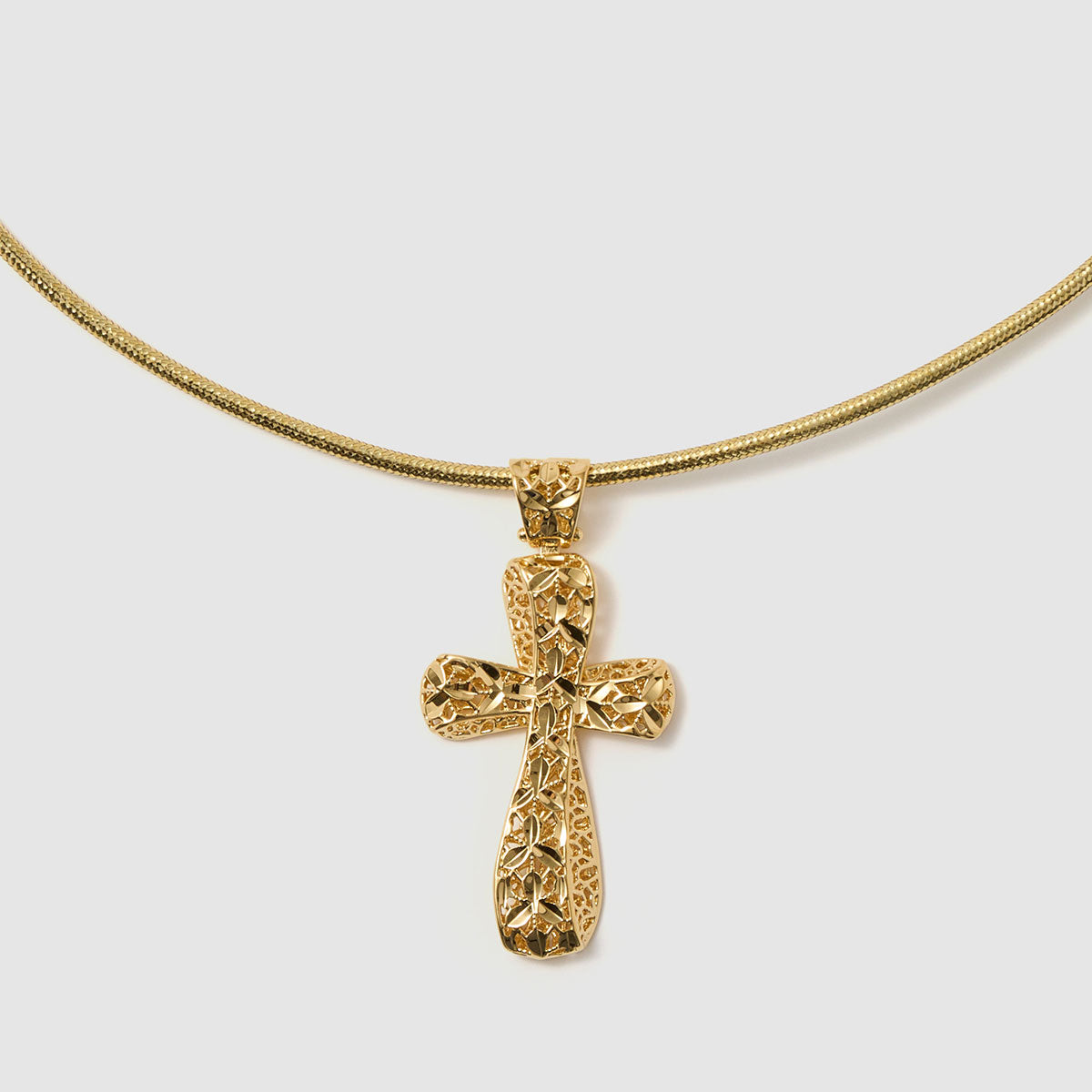 Crossroads of Time, A striking bronze cross pendant with a unique textured finish, merging tradition with a modern edge for a bold statement.
Available in gold and black tones.