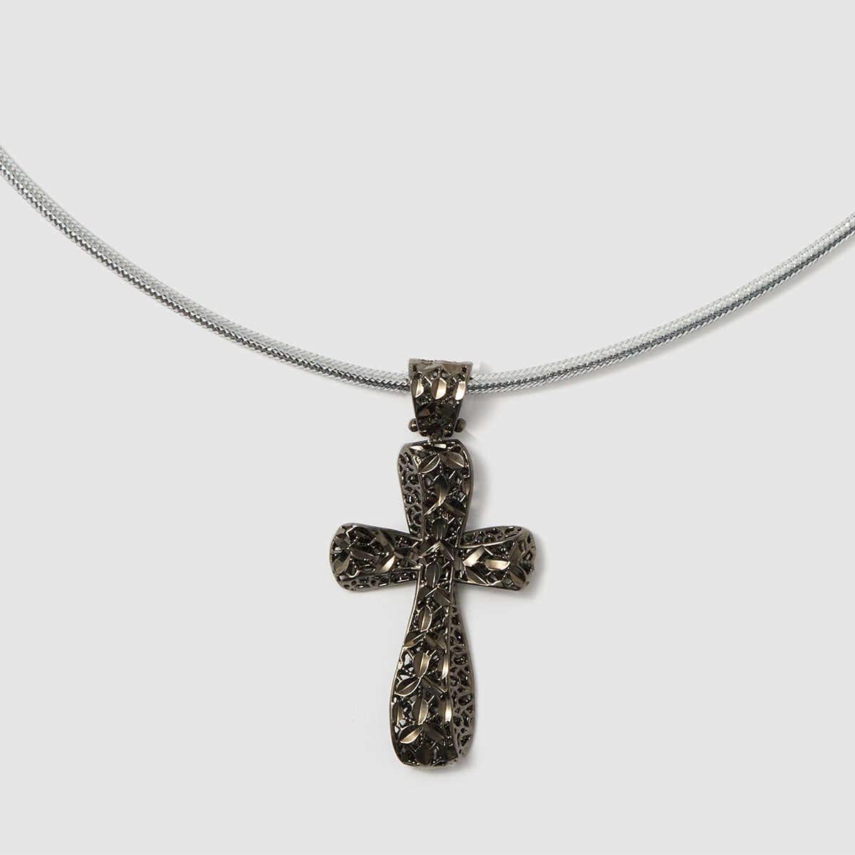 Crossroads of Time, A striking bronze cross pendant with a unique textured finish, merging tradition with a modern edge for a bold statement.
Available in gold and black tones.