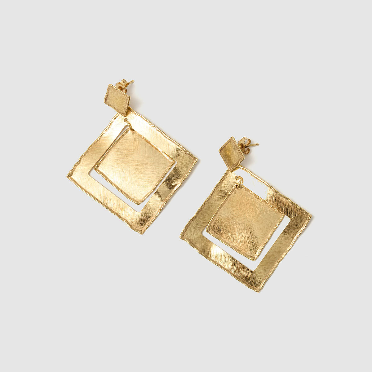 Golden Petals, Bold geometric square earrings crafted from bronze, merging contemporary design with the elegance of nature’s shapes.