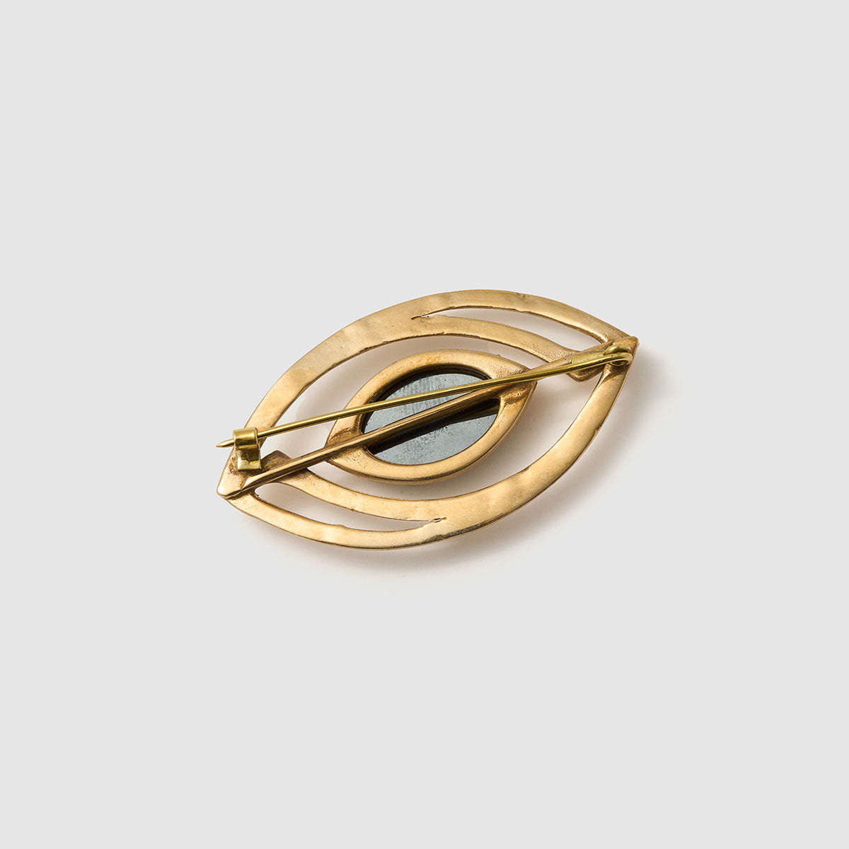 Mystic Vision, Striking brooch in the shape of an eye, crafted from bronze and aluminum with a fiber optic centerpiece.