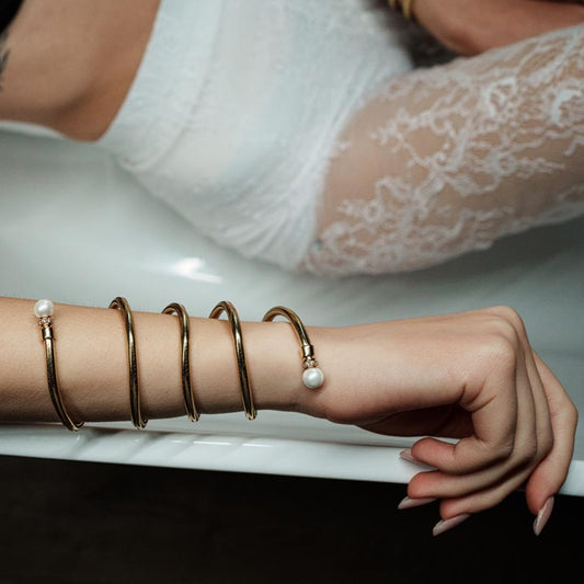 Serpentine Grace, Versatile twisted piece crafted from a blend of bronze, lurex, and thermoplastic, it features elegant twists accented with delicate pearls, embodying a harmonious blend of sophistication and playful design.