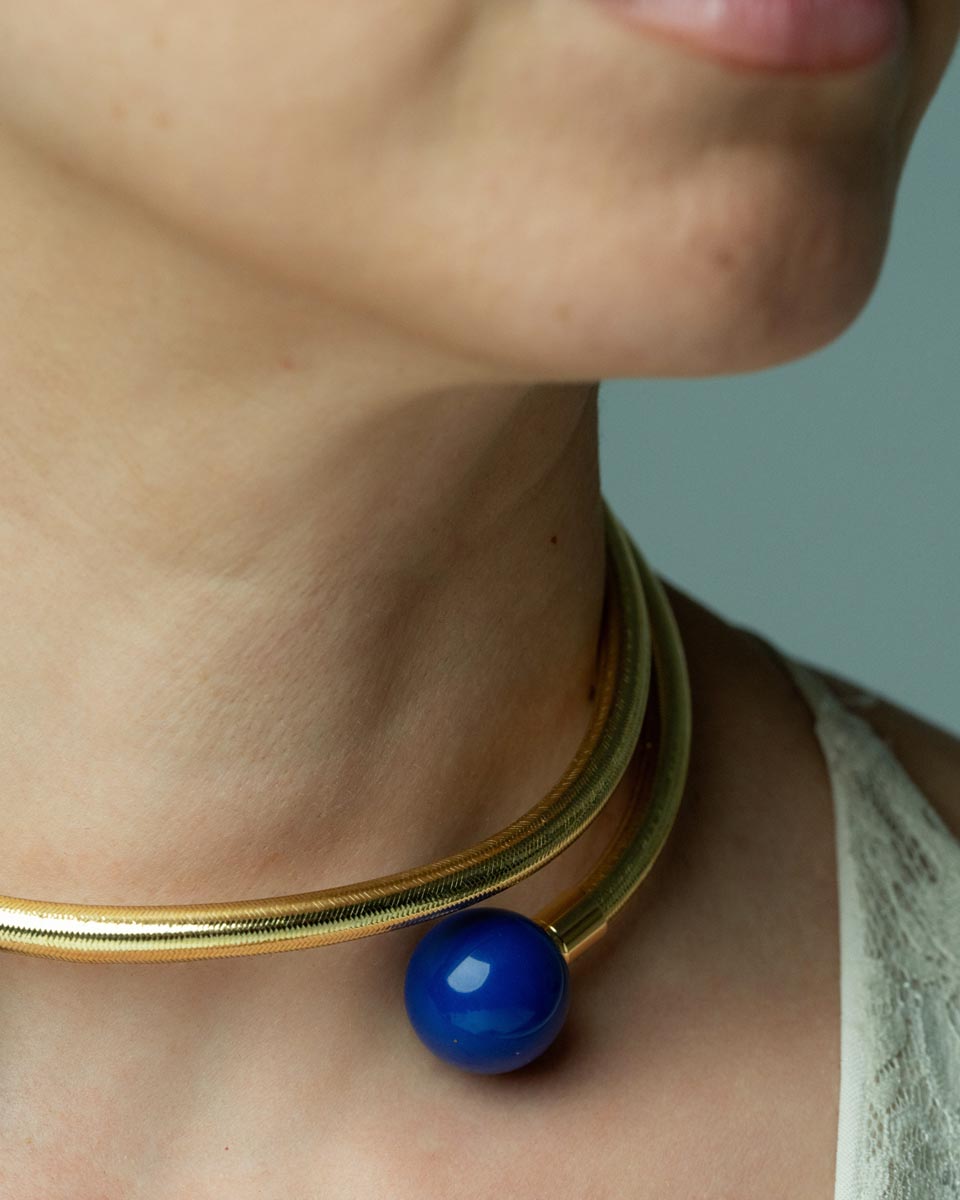 Serpentine Grace, This playful bracelet features a swirling design crafted from bronze, lurex, thermoplastic, and metal, adorned with vibrant lapis lazuli and malachite beads, offering a joyful burst of color that captures the spirit of artistic expression and individuality.