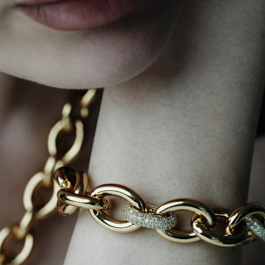Charmed Voyage, Striking chain bracelet with bold brass links and sparkling zircon details.